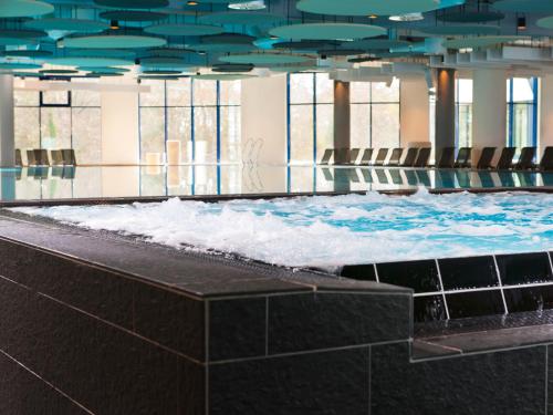 a large swimming pool with snow in a building at aja Warnemünde in Warnemünde