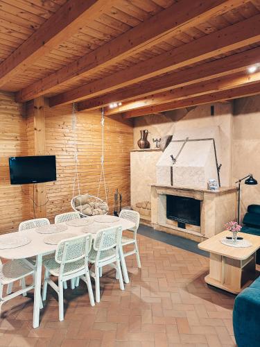 a room with a table and chairs and a fireplace at Vila Ambasada in Šventoji