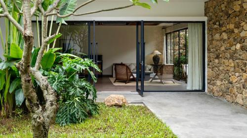 a sliding glass door leading to a patio at Sanhe Daoli Resort in Qingyuan
