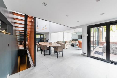 - une salle à manger et un salon avec une table dans l'établissement Maison d'Architecte aux Portes de Paris, à LʼHay-les-Roses