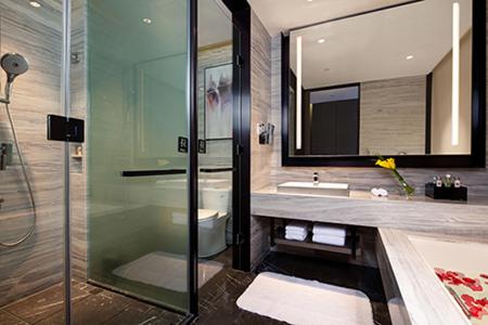 a bathroom with a glass shower and a sink at Crowne Plaza Kunshan, an IHG Hotel in Kunshan