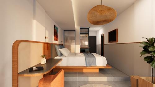 a bedroom with a bed and a desk in a room at YATS Colony in Yogyakarta
