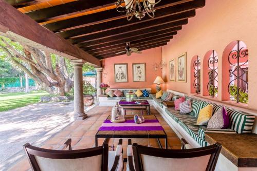 an outdoor living room with a couch and chairs at Casona de Elefantes Boutique Hotel in Cuernavaca