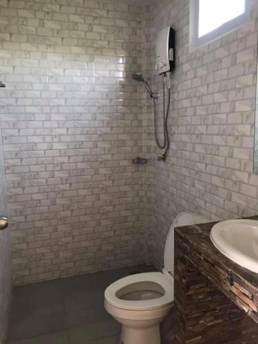 a bathroom with a toilet and a sink at Baan Chay Namm Resort in Bangkok