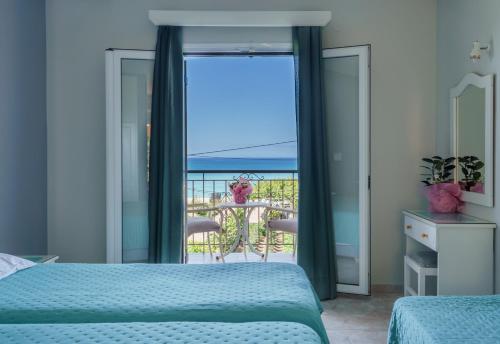 a bedroom with two beds and a view of the ocean at Diona Studios in Lourdhata