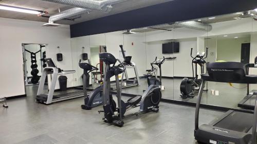 a gym with several exercise bikes and a mirror at Cozy 1BR Apt - Downtown Winnipeg in Winnipeg