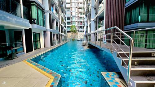 a swimming pool in the middle of a building at Tropical Garden A Studio in Pattaya South