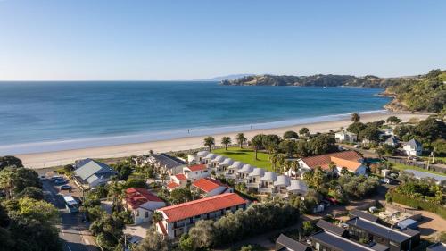 an aerial view of a resort and the beach at Waiata Beach House - Onetangi in Onetangi