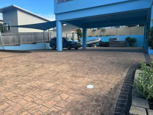 a car parked in a parking lot next to a building at BlueWater Apartments in Merimbula