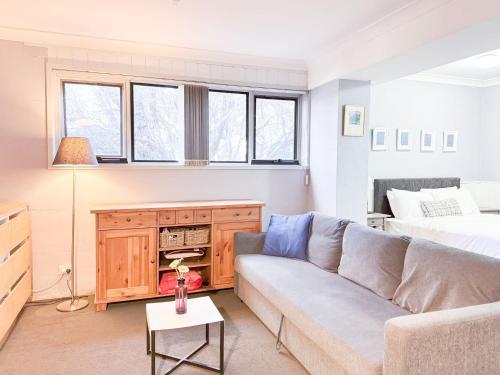 a living room with a couch and a bed at Kirkwood 4A in Thredbo