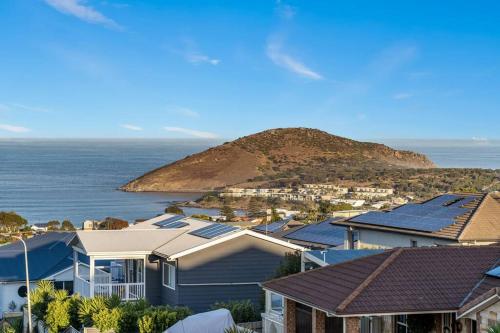 a group of houses with solar panels in front of the ocean at Oceanview at Encounter - 4BR Family Escape in Encounter Bay