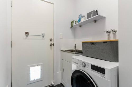 a kitchen with a washing machine and a sink at Oceanview at Encounter - 4BR Family Escape in Encounter Bay