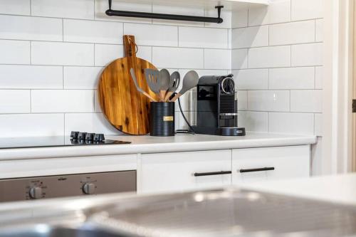 a kitchen counter with a cutting board and utensils at Oceanview at Encounter - 4BR Family Escape in Encounter Bay