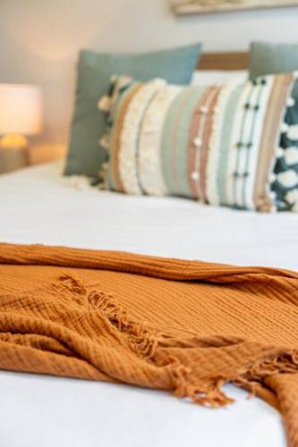 a close up of a bed with pillows on it at Oceanview at Encounter - 4BR Family Escape in Encounter Bay