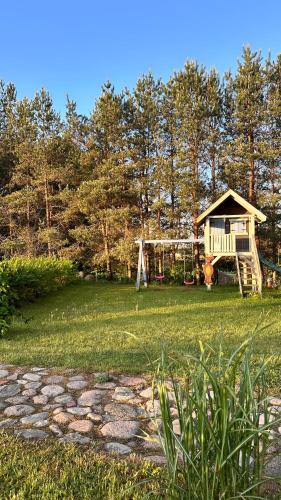 a yard with a house and a playground at Cisowe Sioło in Jeleniewo