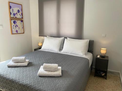 a bedroom with a bed with two towels on it at TERRA HOMERICA in Chios