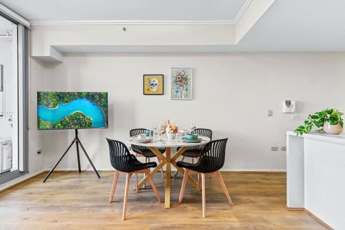 a dining room with a table and chairs at Stunning City and water view 2 bedrooms & 2 bathrooms apartment in Sydney