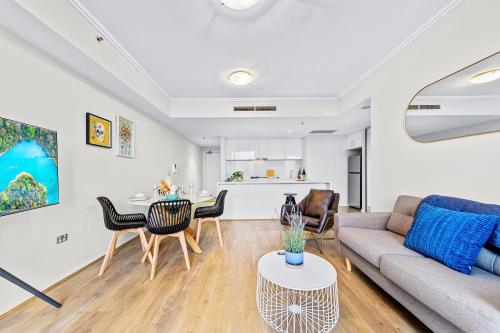 a living room with a couch and a table at Stunning City and water view 2 bedrooms & 2 bathrooms apartment in Sydney