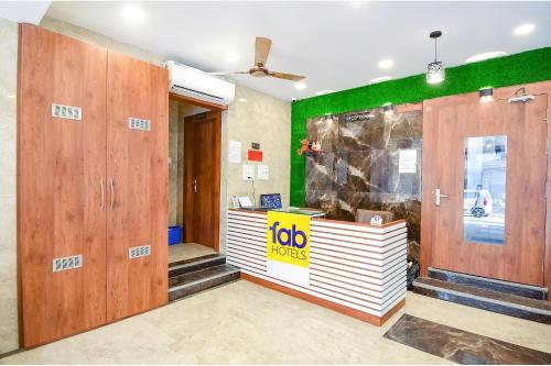 a lobby with a job counter and green walls at FabHotel Dreamworld Residency - Near bisarjan ghat in Kolkata