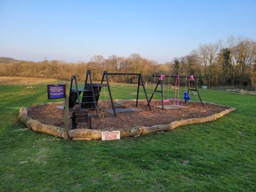 a playground in the middle of a field at Belle Village, non electric ,Rent a bell tent, BEDDING NOT SUPPLIED in Narberth