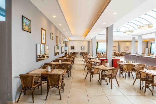 a dining room with tables and chairs in a restaurant at BELPOİNT BEACH HOTEL in Antalya