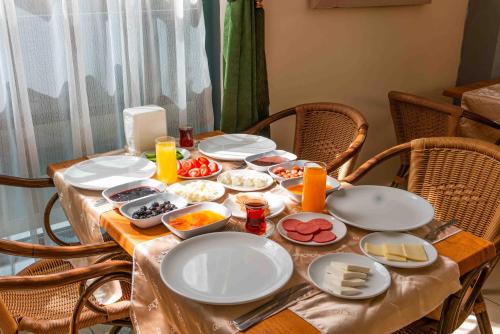 a table with plates and bowls of food on it at BELPOİNT BEACH HOTEL in Antalya