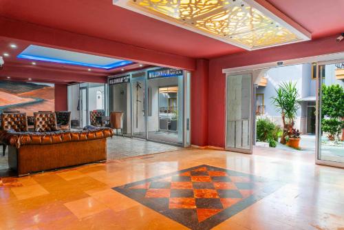 an empty lobby with leather furniture and glass doors at BELPOİNT BEACH HOTEL in Antalya