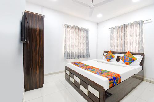 a bedroom with a large bed in a room at FabHotel Silver 7 Homes in Hinjewadi