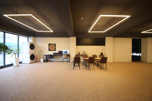 a large room with a table and chairs in it at Brown Dot Hotel Sinan in Gwangju