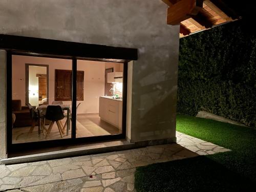 a view of a kitchen and a dining room through a window at L'armonia della natura in Aosta