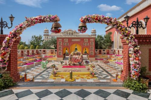 an artificial garden in front of a building at Noormahal Palace Hotel in Karnāl