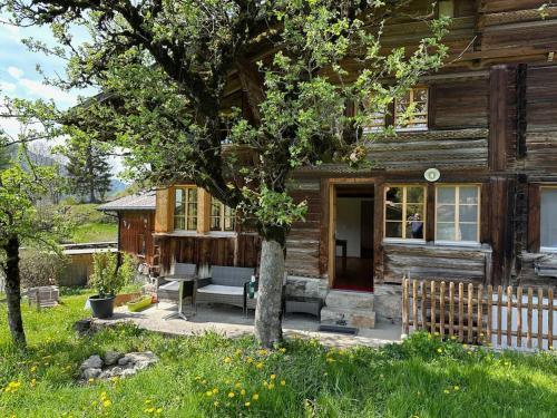 a wooden house with a bench in front of it at 3-Bedrooms Apartment in a Chalet in Meiringen