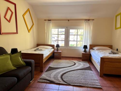 a living room with two beds and a couch at Agroturystyka „U Rzeźbiarza” in Sławno