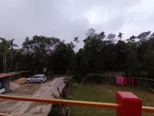 a car parked in a parking lot with a clothes line at Benjamin homestay in Mawlynnong