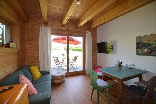 a living room with a blue couch and a table at Augenweide in Prien am Chiemsee