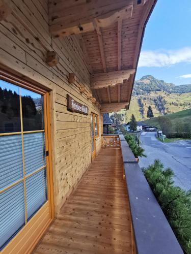 a wooden building with a wooden walkway at Gschlössl, Ferienhaus in Rauris