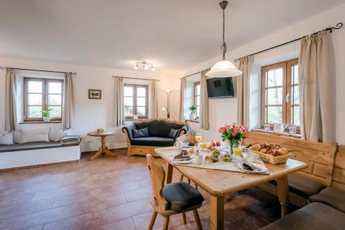 ein Wohnzimmer mit einem Tisch und einem Sofa in der Unterkunft Möderlhof - Fraueninsel in Eggstätt