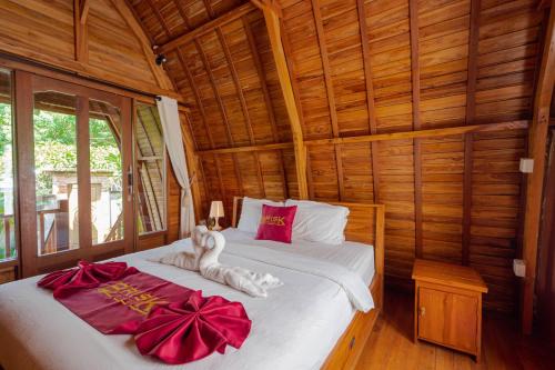 Tempat tidur dalam kamar di Brisk Homestay at Uluwatu RedPartner