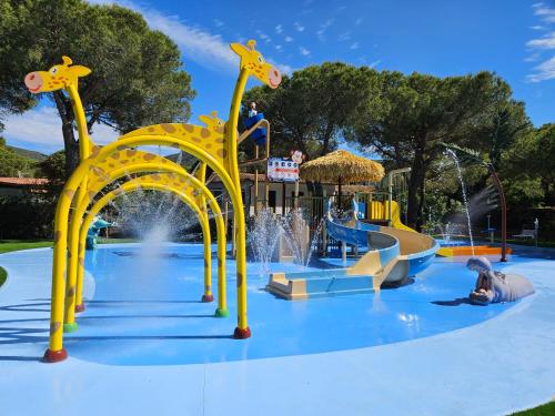 a water park with a theme park with a water slide at Camping Lacona Pineta in Capoliveri
