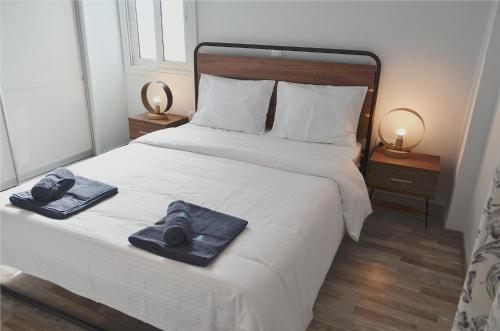 a bedroom with a bed with two towels on it at Gtrip Gazi Duplex Apartment - 33701 in Athens