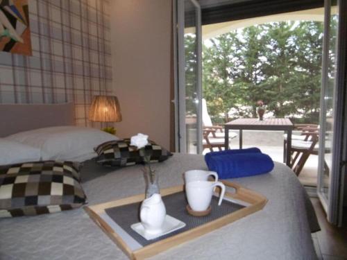 a bed with a tray with a vase with flowers on it at Villa Luka Apartment Cream in Funtana