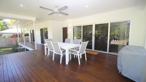 a dining room with a white table and white chairs at Le Belle Aimante, Magnetic Island in Horseshoe Bay