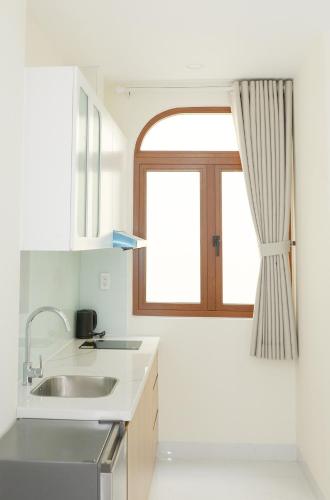 a kitchen with a sink and a window at IN URBAN in Ho Chi Minh City