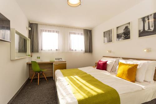 Postel nebo postele na pokoji v ubytování Hotel Compliment