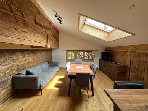 a living room with a couch and a table at 5 Bedrooms Chalet Brünig in Meiringen