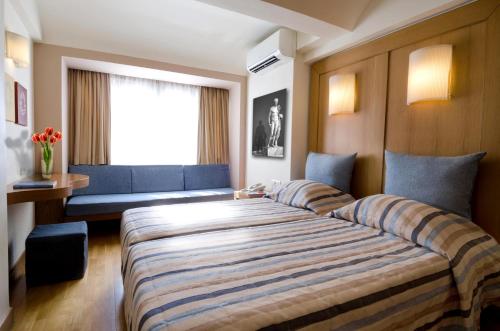 Postel nebo postele na pokoji v ubytování Hermes Hotel