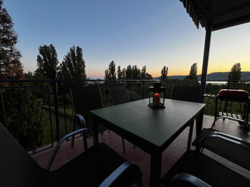 a table and chairs on a balcony with a view at Levendulás in Szigliget