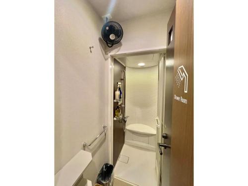 a bathroom with a toilet and a sink and a mirror at KAJIMACHI NO YU SPA SOLANI - Vacation STAY 26782v in Hamamatsu