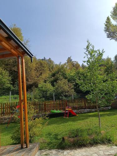 a yard with a playground and a wooden fence at Wooden Mountain Villa in Berovo