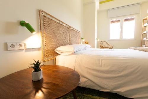 um quarto com uma cama e uma mesa de madeira em RaíZes 22 - Apartamento 5 em Puebla de Don Fadrique